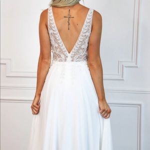 Floor length white gown with slit vneck and vback